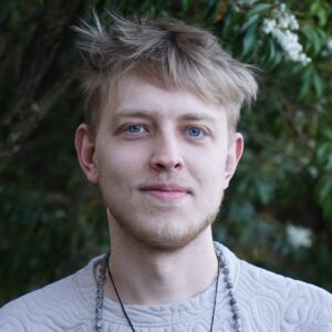 Esa, a psilocybin facilitator at Vital Reset in Oregon, standing outdoors with a peaceful expression. He offers compassionate, safe psilocybin treatment and personalized support for clients navigating trauma, depression, and self-discovery.