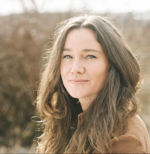 Tracey, a psilocybin facilitator and clinical herbalist, pictured outdoors with natural light. She offers safe psilocybin treatment, teaches at the Changa Institute, and brings over two decades of experience with plant medicine and psychedelic support.