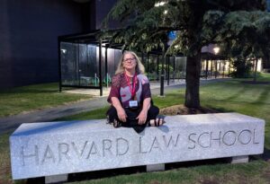 Heidi Venture, co-owner of Vital Reset in Hood River, Oregon, sitting on the Harvard Law School bench after presenting on Oregon’s psilocybin regulatory system and safe psilocybin treatment at the Petrie-Flom Center’s psychedelic law bootcamp.