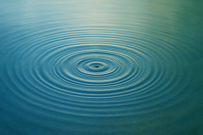 a calm surface in blue and green tones, symbolizing the long-term effect of a single action.