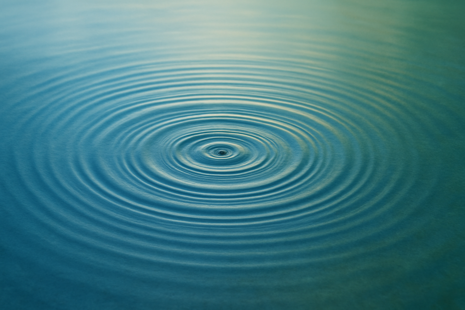 a calm surface in blue and green tones, symbolizing the long-term effect of a single action.